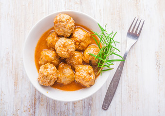 Bowl with meatballs and tomato sauce