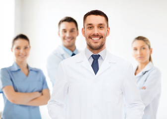 smiling male doctor in white coat