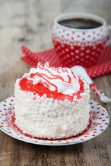 Cake with white air protein cream and red confectionery sprinkle