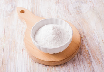 Fototapeta na wymiar salt in a white bowl on white wooden table