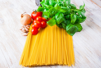 spaghetti ingredients on a white wooden table