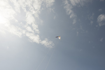 Man flying a kite on the beach.