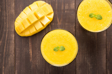 Top shot mango smoothie on wooden table