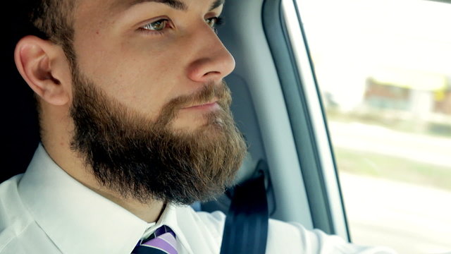 Serious handsome man driving closeup