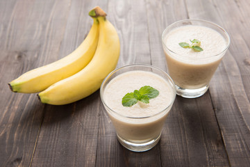 Banana smoothie on wooden table.