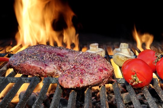 Bloody Strip Steak, Tomatoes And Mushrooms On Hot Grill