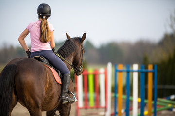 Young woman show jumping with horse - obrazy, fototapety, plakaty