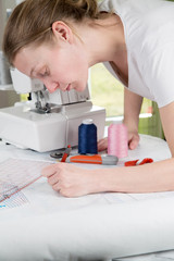 Woman drawing a sewing pattern