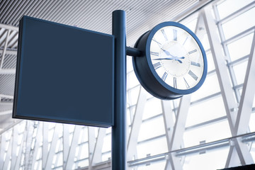 Clock at an international airport and sign