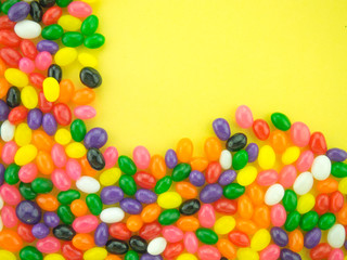 Fototapeta na wymiar Jelly Beans Frame and Background ( Yellow Background )