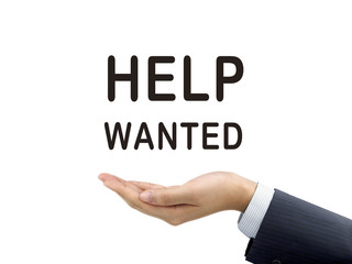help wanted words holding by businessman's hand