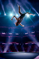 Young man is jumping on trampoline