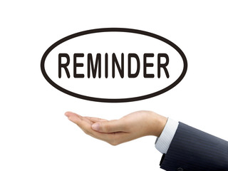 reminder word holding by businessman's hand