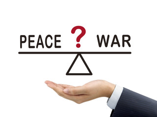 balance between peace and war holding by businessman's hand