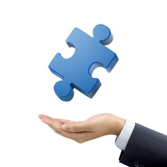 businessman's hand holding jigsaw puzzle piece
