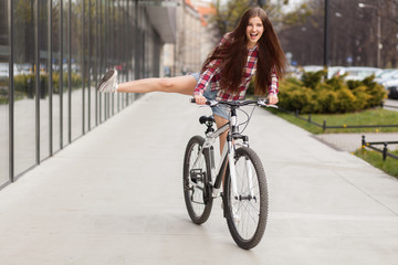 Fototapeta na wymiar Young beautiful woman on a bicycle