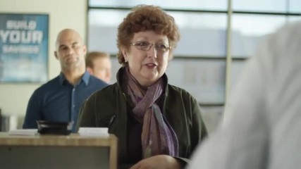 Female customer gets cash from bank teller.  