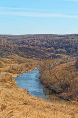 Spring landscape with river and blue sky, vertical composition