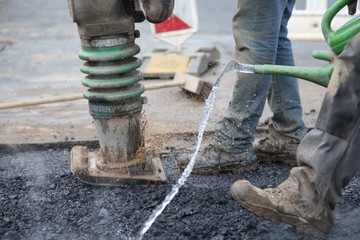 Bauarbeiter mit Vibrationsstampfer