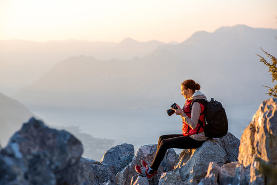 Young photographer on the top of mountain - Powered by Adobe