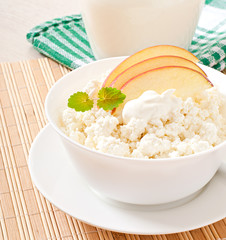 Cottage cheese with apples and sour cream for breakfast close up