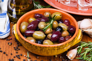 Olives in bow on wooden table