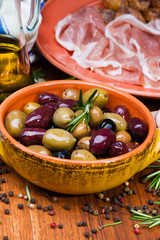 Olives in bow on wooden table