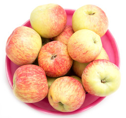 red and yellow apples in a red plate