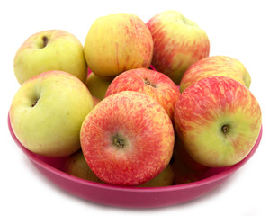 red and yellow apples in a red plate