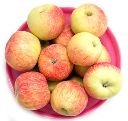 red and yellow apples in a red plate