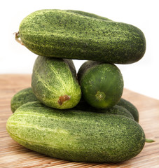 fresh cucumbers on a wooden background