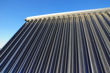Fototapeta na wymiar Closeup of vacuum solar water heating system on the house roof