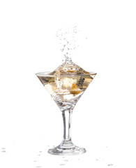 A martini glass on a white background; the water ripples