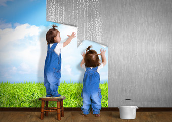 Little twins doing repair at home, hanging wallpaper