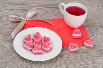 candies in a heart shape and tea