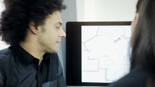Handsome cool modern architect talking to partner about project closeup