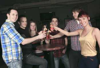 A group of friends drink on hand have some fun