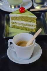 green tea cake with a cup of hot green tea latte