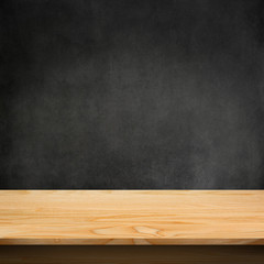 Wood table with dark concrete texture background