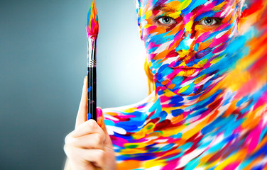 Portrait of the bright beautiful girl with art make-up and brush