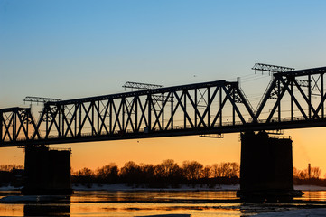 Fototapeta premium Railroad bridge and construction site on river bank 
