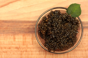 Black and red caviar in glass container