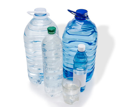Several bottles and glassful of water
