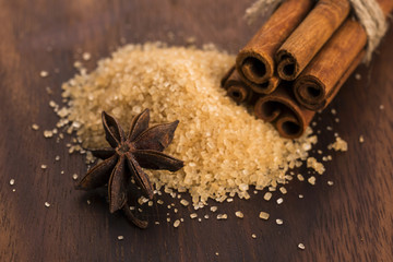 Cinnamon sticks with pure cane brown sugar on wood background