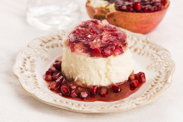 coconut panna cotta dessert with pomegranate