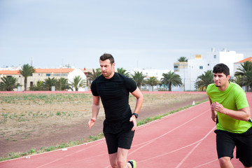 Fototapeta premium Two men running on running track