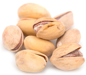Salted pistachios on white background