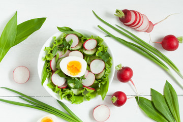 Plate of healthy seasonal salad with ripe vegetables on white