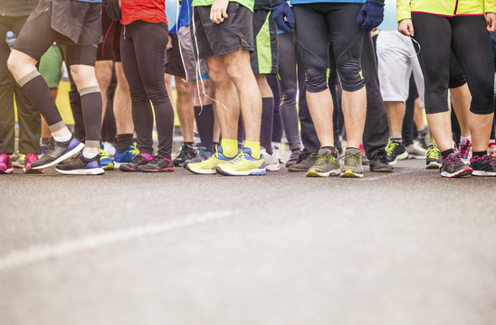 Detail of the legs of runners at the start of a marathon race