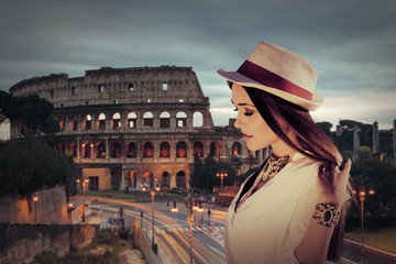 Young woman facing the Colosseum in Rome